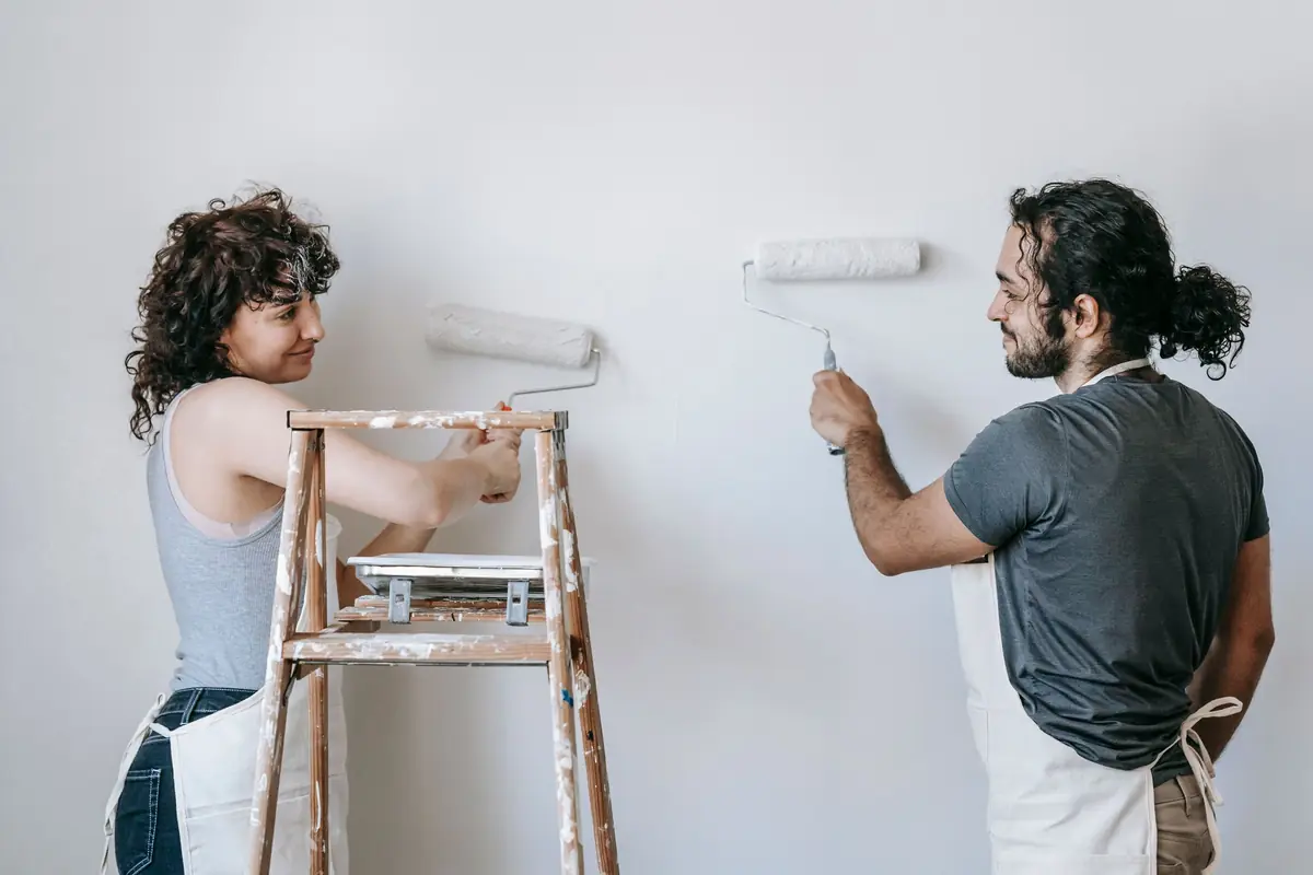 People painting a wall together — painting help in Oceanside